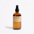 KarLen's Inc Amber & Moss Room & Linen Spray bottle on a wooden table