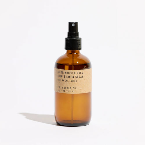 KarLen's Inc Amber & Moss Room & Linen Spray bottle on a wooden table